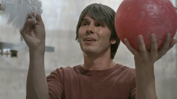 BBC presenter Brian Cox drops  a bowling ball and a feather in NASA's Space Simulation Chamber in an experiment to see which would hit the ground first in a vacuum.  