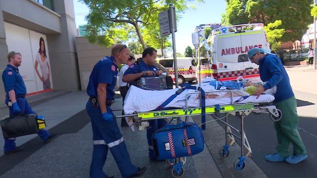Paramedics take Amy Rickuss from The Cosmetic Institute to Westmead Hospital in January. 