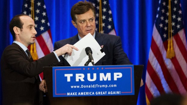 A Trump campaign aide covers the microphone while Paul Manafort checks the teleprompter ahead of a Donald Trump speech in New York in June.