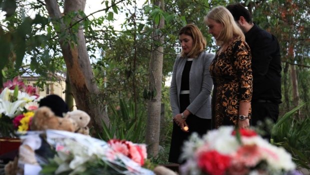 Minister for the Prevention of Domestic and Family Violence Shannon Fentiman and Parkinson Ward councillor Angela Owen-Taylor pay their respects at a candelight vigil for Queenie Xu in a park across the road from where she was stabbed to death in Parkinson.