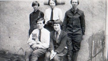Garage girls circa 1924. Top centre, Heather Buchanan, seated from left, Ruth Snell with garage cat and Marie Edie. Others' names unknown.