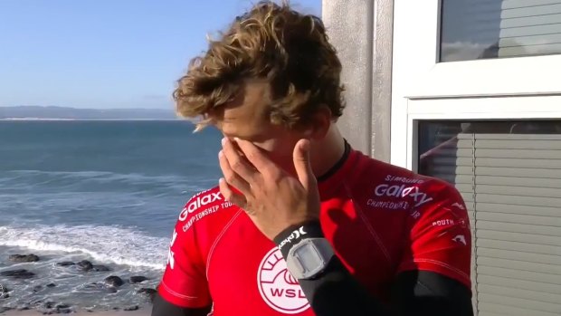 Shaken: An emotional Julian Wilson speaks about how he tried to get to Mick Fanning as the shark lunged. 