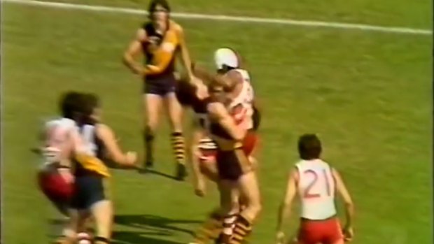 Bulldogs hard nut Basil Campbell cleans up Barry Beecroft at the start of the 1981 WAFL Grand Final.