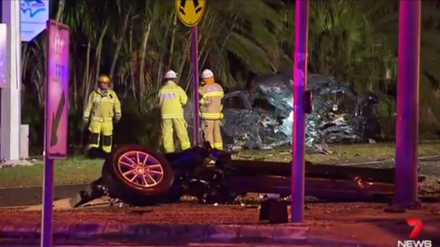 A woman died and another was injured when a car hit traffic lights on the Gold Coast.