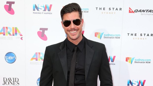 The Bachelor Sam Wood showed off the fruits of his gym labour in a suave black Calibre suit and added some black rimmed Ray Ban aviators for ultimate swag appeal. 