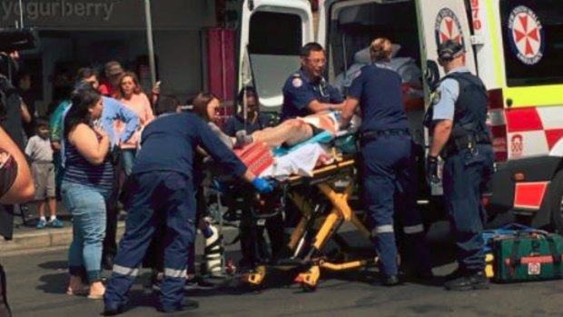 Ambulance workers attend to a teenager stabbed in Blacktown in November.