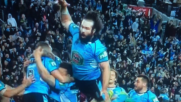 Aaron Woods finds air when celebrating the Blues' win.