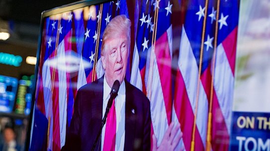 US President-elect Donald Trump is seen speaking on a television on the floor of the New York Stock Exchange (NYSE).