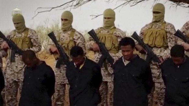 Islamic State militants stand behind what are said to be Ethiopian Christians in Wilayat Fazzan, in this still image from an undated video made available on a social media website on April 19, 2015. 