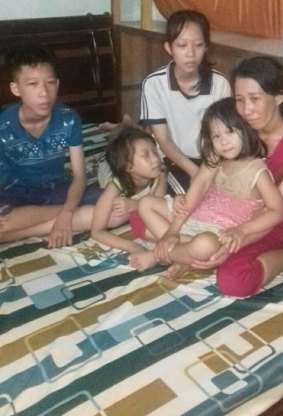 Tran Thi Thanh Loan and her four children. She is fighting a prison conviction. Her husband, Ho Trung Loi, has been jailed for two years.