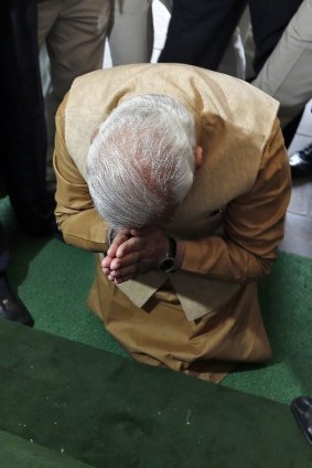 Humbled: Modi prostrates himself at the entrance to India's parliament house.