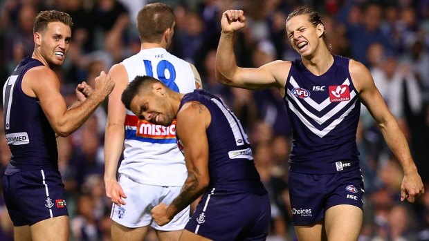 The Dockers celebrate an upset win over the reigning premiers.