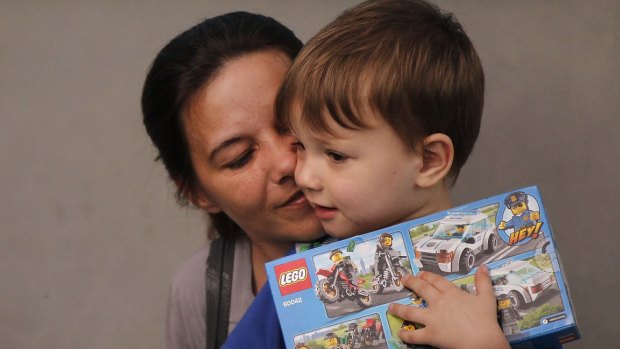 Sabine Atlaoui, the wife Serge Atlaoui, holding their son Yasen Atlaoui (right) while they wait to visit him on Nusakambangan prison island where the Indonesian authorities plan to execute him.