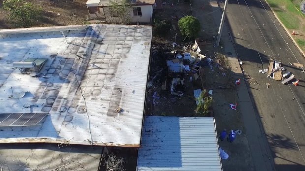 An image shot from a drone shows the remains of a caravan that exploded in the Mount Isa suburb of Mornington, killing Charlie Hinder, 39, along with his children Nyobi, 7, and River, 4.