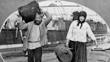 Two Russian immigrants disembarking from a ship in Brisbane. (Circa 1931)