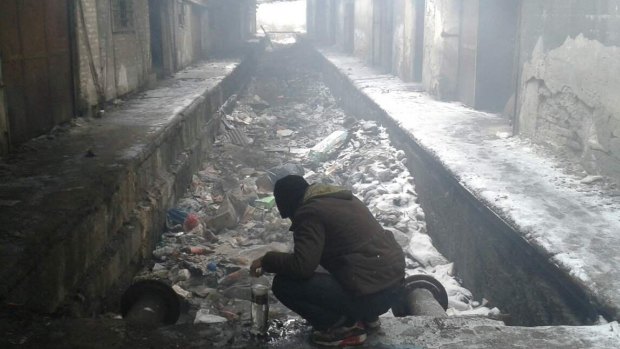 Refugees in the snowy, cold warehouses in Serbia.