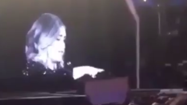 Adele instructs a fan to watch the show in real life, "rather than through your camera".