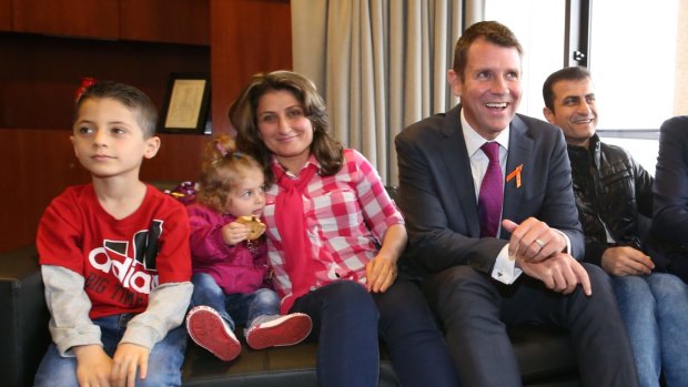 The Kaky family, originally from Iraq, with Premier Mike Baird.