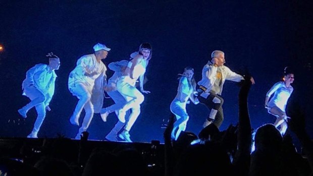 Justin Bieber flanked by 20 backup dancers.