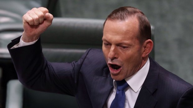 Prime Minister Tony Abbott uses his fist to emphasise a point while speaking in Parliament House. 