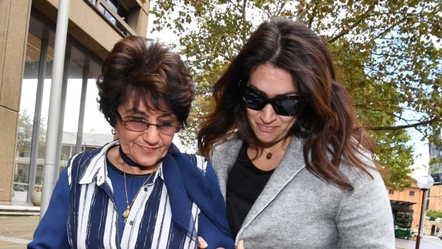 Judith Obeid, left, with a family member outside court earlier this year. 