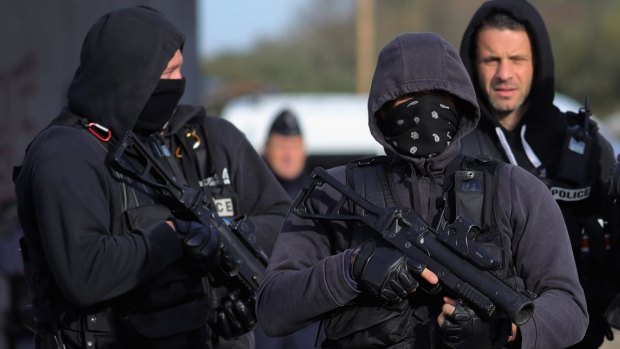 French police clear the main entrance to the Calais Jungle on Thursday.