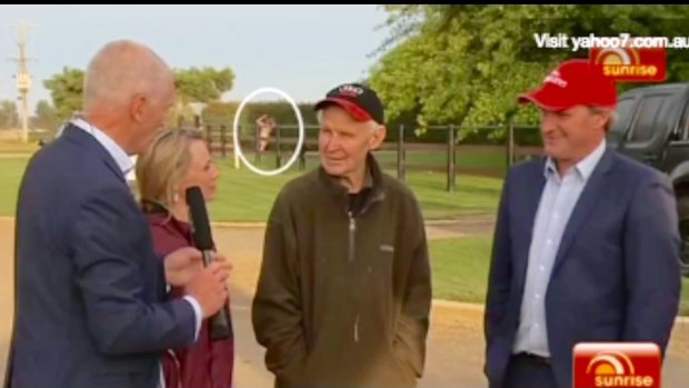 A streaker distracts Simon Reeve's interview with Melbourne Cup winning trainer Darren Weir and Paddy Payne, father of  winning rider Michelle Payne.