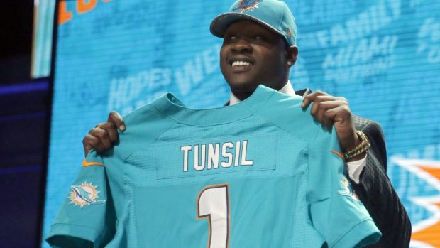 Eventful day: Laremy Tunsil poses for photos after being selected by the Miami Dolphins as the 13th pick in the first round.