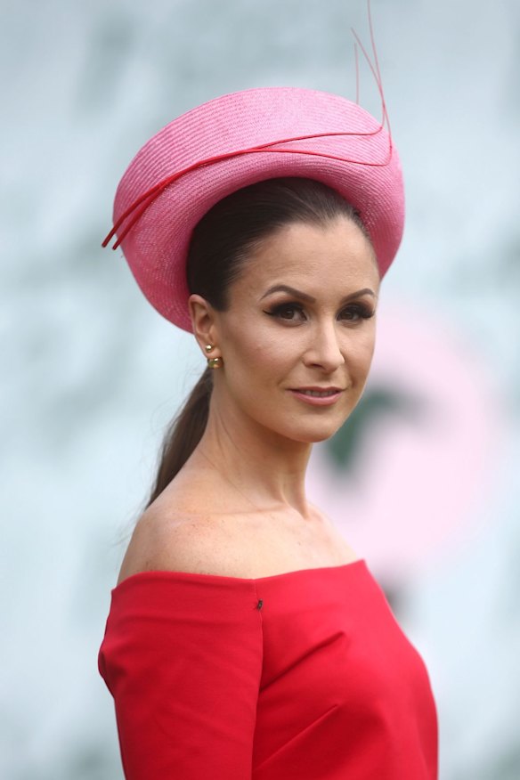 A racegoer poses on Emirates Melbourne Cup Day at Flemington Racecourse.