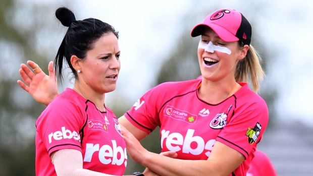 In the zone: Marizanne Kapp of the Sixers (left) celebrates one of her two wickets.
