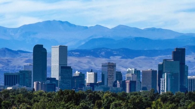 The Denver city skyline, downtown against the backdrop of the Rocky Mountains.