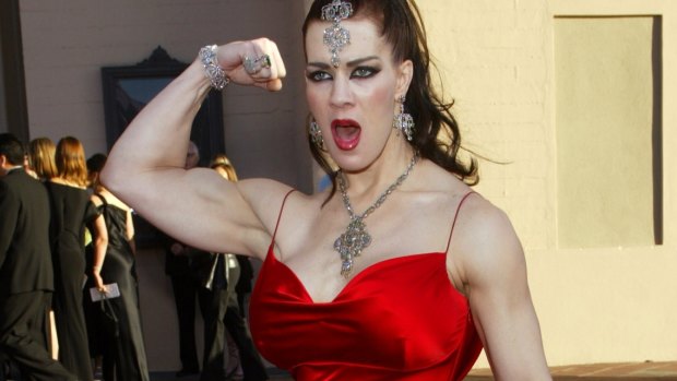 Joanie Laurer flexes her bicep as she arrives at the 31st annual American Music Awards, in Los Angeles in 2003.