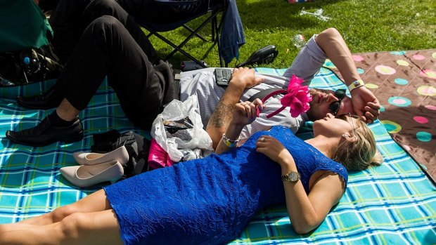Punters bask in the sun at last year's Melbourne Cup Day. This year will be a bit cooler.