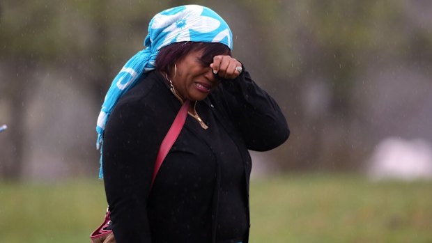 A woman named Vera weeps at Paisley Park at the news of the death of artist Prince.  