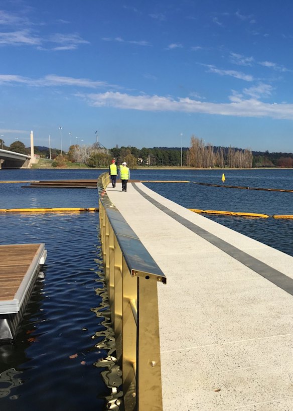 Andrew Barr and Mick Gentleman check out the first part of the West Basin boardwalk on Tuesday. At the end is a wooden platform with steps to the water. The photograph looks towards Parliament House.