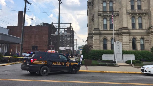 A police vehicle responding to the ambush-style shooting of Jefferson County Judge Joseph Bruzzese Jr. as he walked toward the Jefferson County Courthouse. 