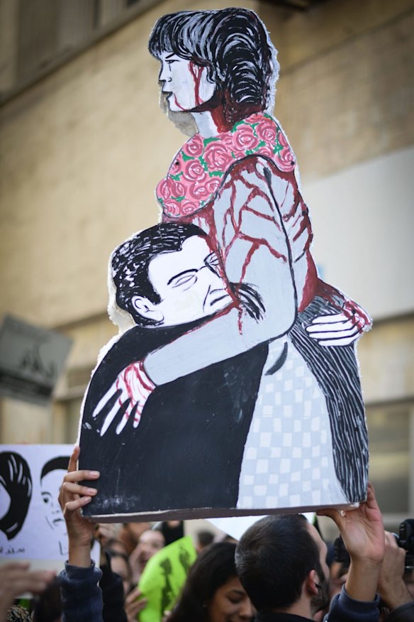 An Egyptian demonstrator holds a placard depicting Shaima al-Sabbagh.