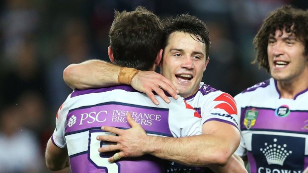 Job done: Melbourne Storm players embarace at full time in Sydney.