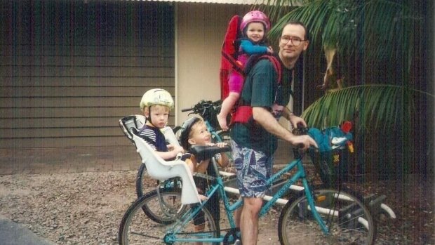 Dr Bryant as a young dad with his children.