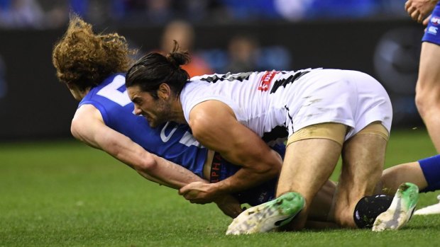 Ben Brown hit the turf head first in a tackle from Collingwood ruckman Brodie Grundy at Etihad Stadium on Saturday night.