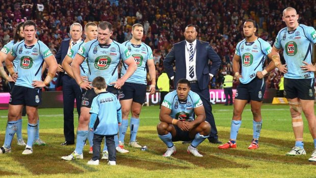 Empty: Blues players stand dejected after their crushing defeat in the Origin decider.