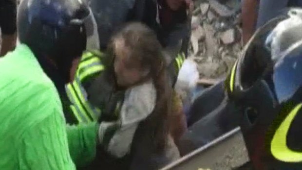 A 10-year-old girl is pulled alive from the rubble following an earthquake in Pescara Del Tronto, Italy.