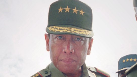 Indonesian Armed Forces chief Gen. Wiranto, center, examines a gun used for firing tear gas canisters in Jakarta in this Monday, March 1, 1999, file photo. 