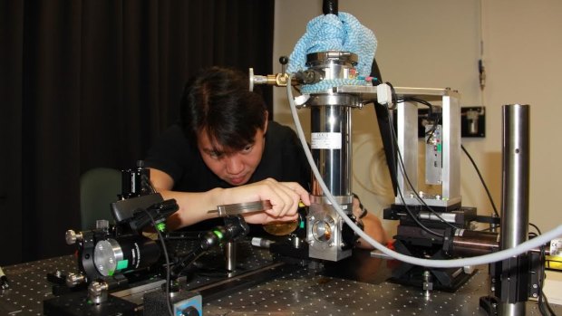 UQ School of Information Technology and Electrical Engineering Dr Yah Leng Lim works on his laser prototype.