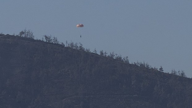 A pilot parachutes out of the warplane which went down in Syria's north-western Turkmen town of Bayirbucak. .