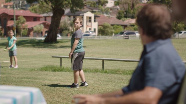 In the TV ad, a father also yells to his son playing, "Don't throw like a girl".