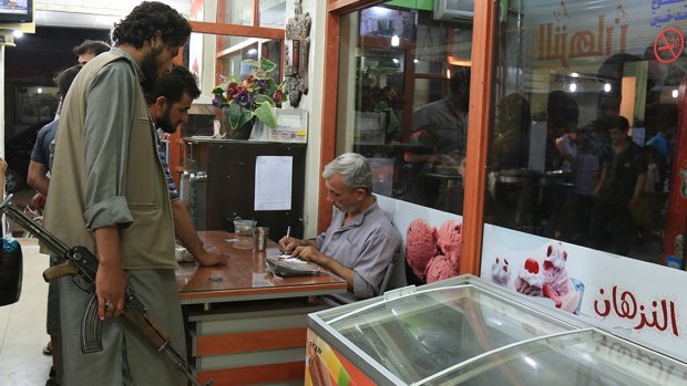 A Television Channel run by the Islamic State Militant Group shows ice cream being sold in the IS held Syrian town of Deir al-Zor in June.
