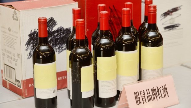 Bottles of counterfeit Penfolds wine being sold through Alibaba, shown at a press conference in Shangha. 