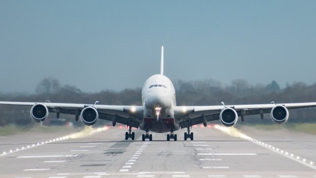 Gatwick Airport, England, UK â December 09 2018: Front on view straight down the runway of an Emirates Airline A380 Airbus just as it takes off from London Gatwick Airport heading for Dubai.