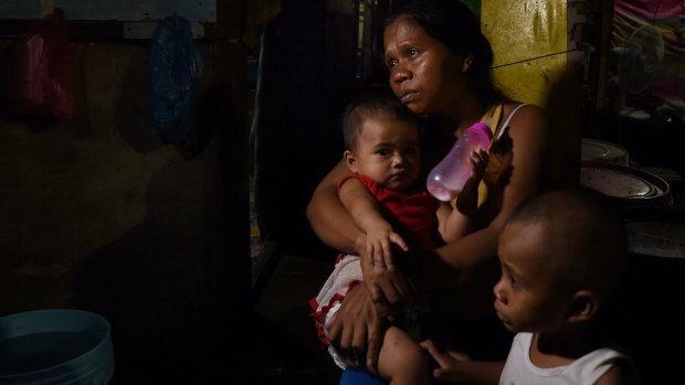 Seven-month pregnant Ruth-Jane Sombrio, widow of Rogie Sebastian, with their daughter Rogielyn (left) and son Rogie.